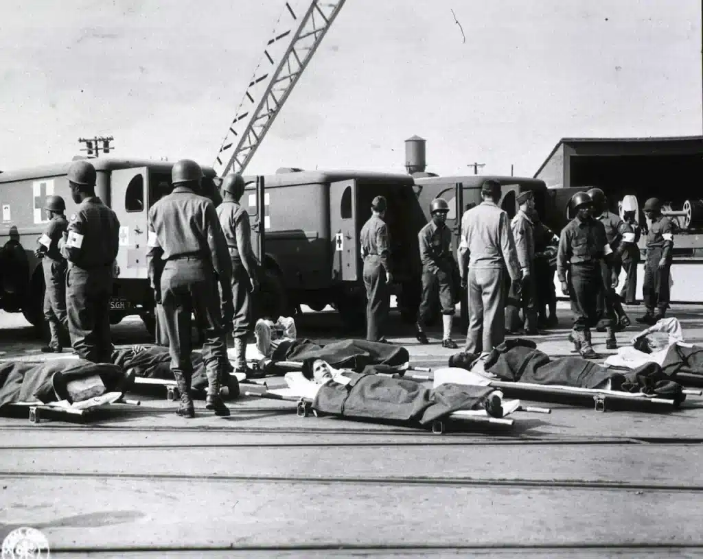 WWII Soldiers on stretchers await for ambulances 