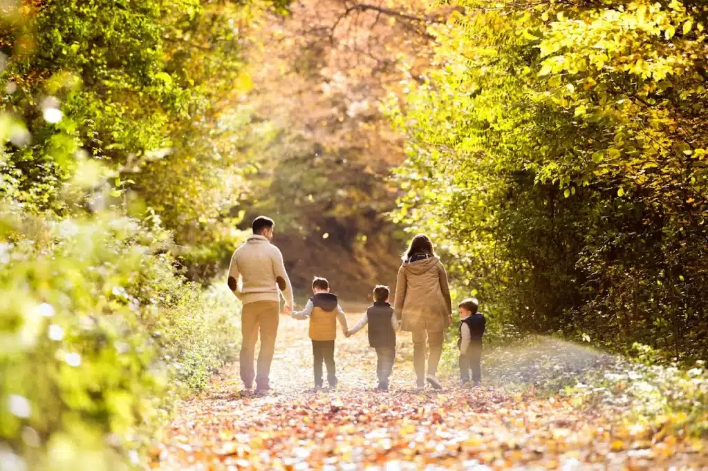 A Family with Three Sons Walking on the Bush