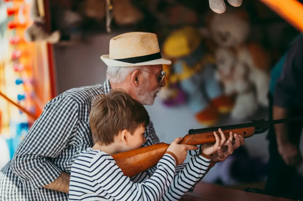 A Grandfather Teaching his Grandson How to Shoot