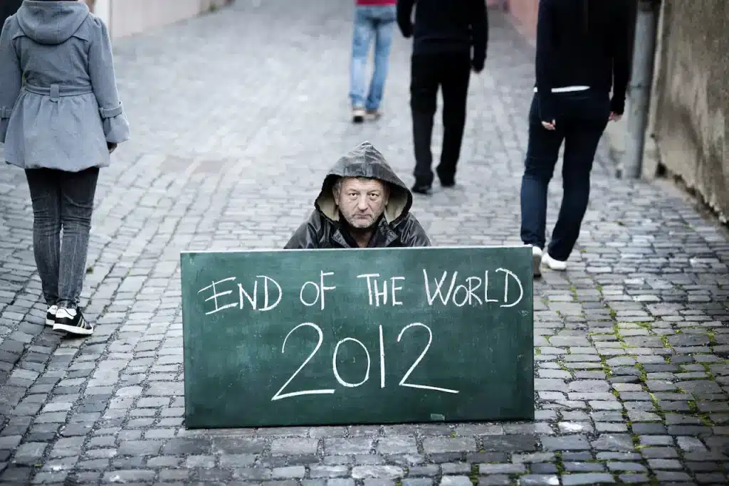 A Person Holding A Sign That Says The End of the World 2012