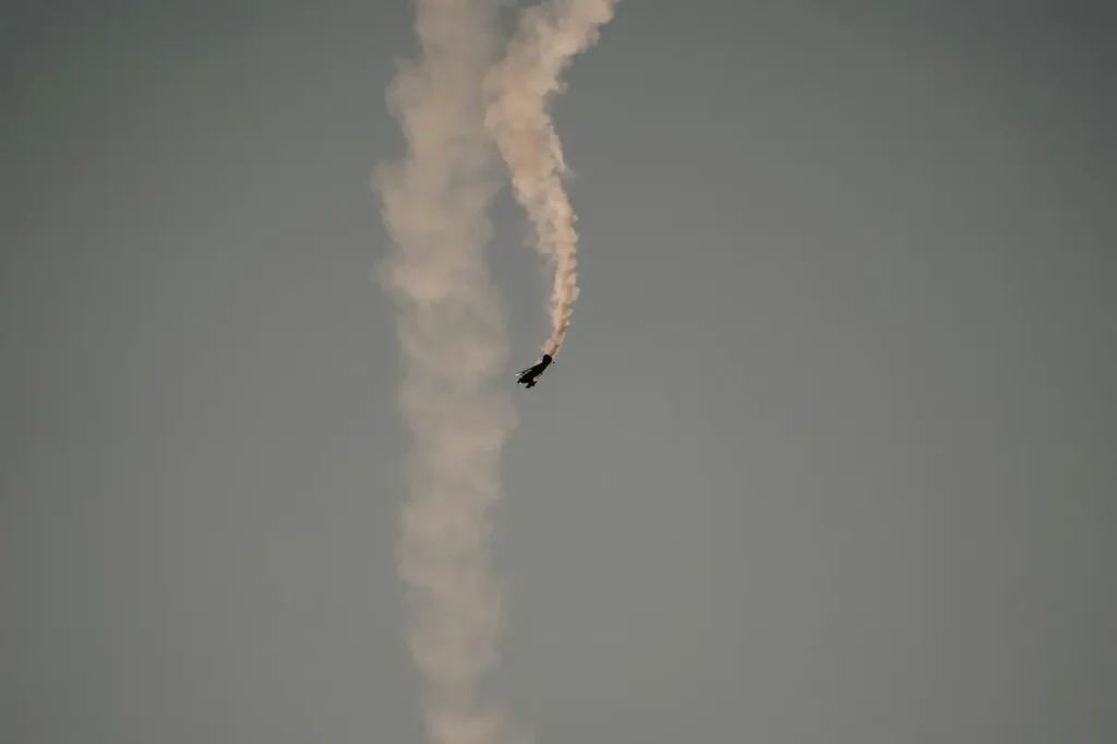 A Small Airplane Flying in the Sky with Smoke Coming Out