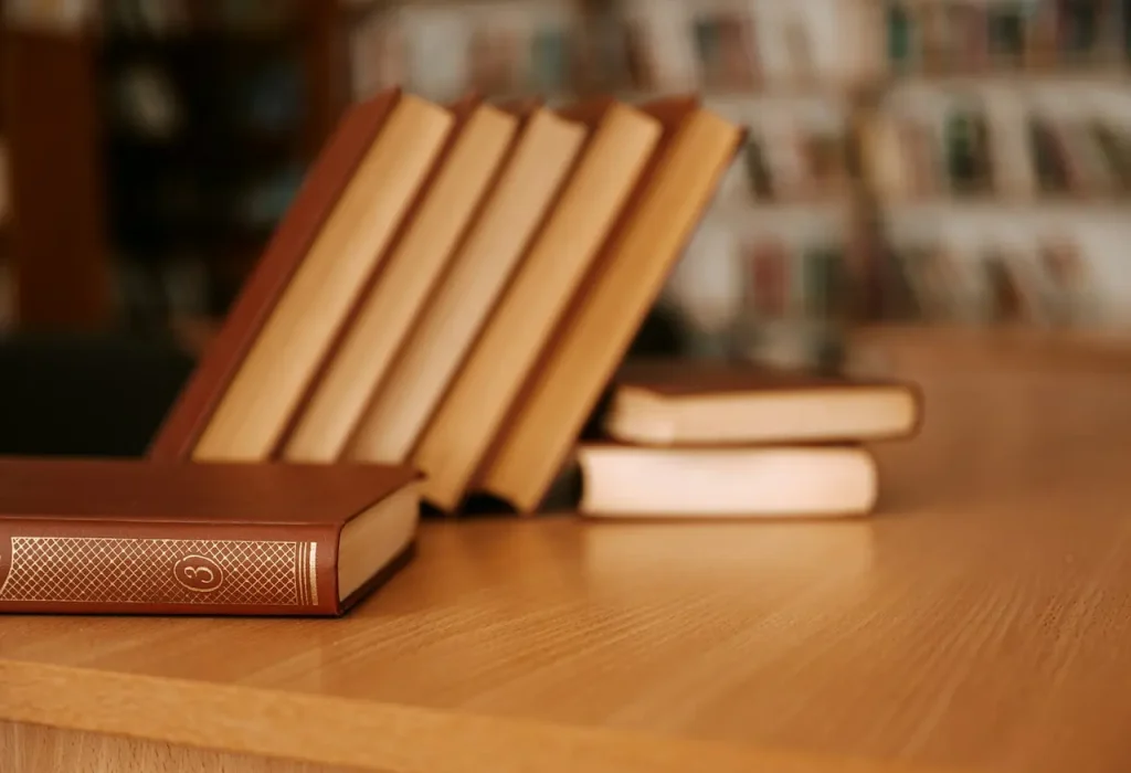 Books on a Wooden Desk Arranged Neatly 