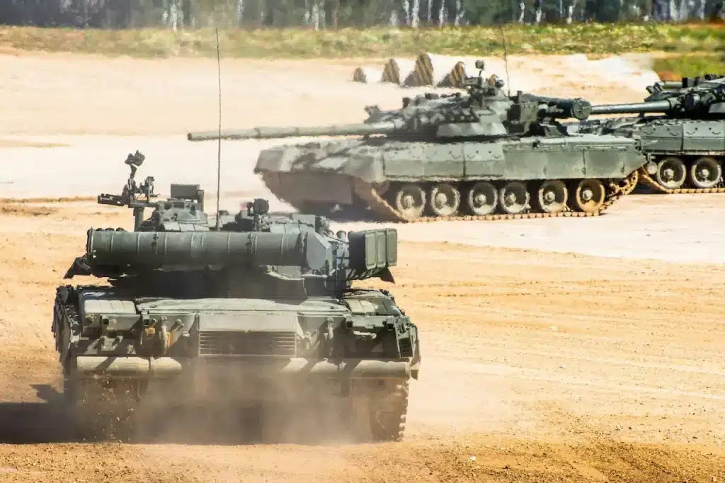 Military Tank Rides Through the Field 