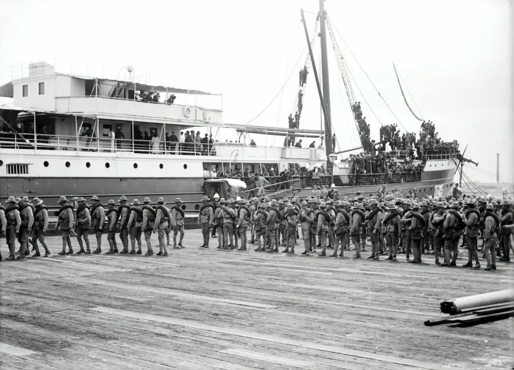 Photography of Soldier Marching Beside Passenger Ship
