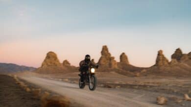 man riding motorcycle on road during daytime