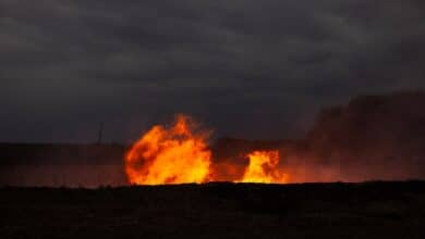 Flames erupting from the ground at dusk