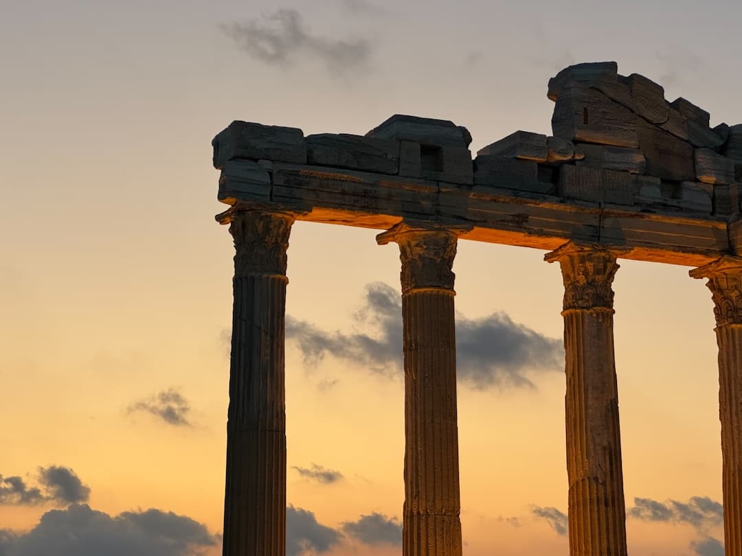 Ancient ruins with columns against a sunset sky