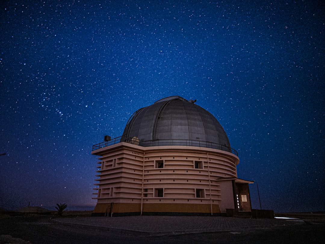 A large dome with a star filled sky in the background