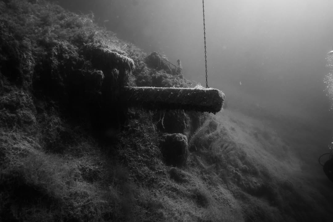 A black and white photo of a man on a rope