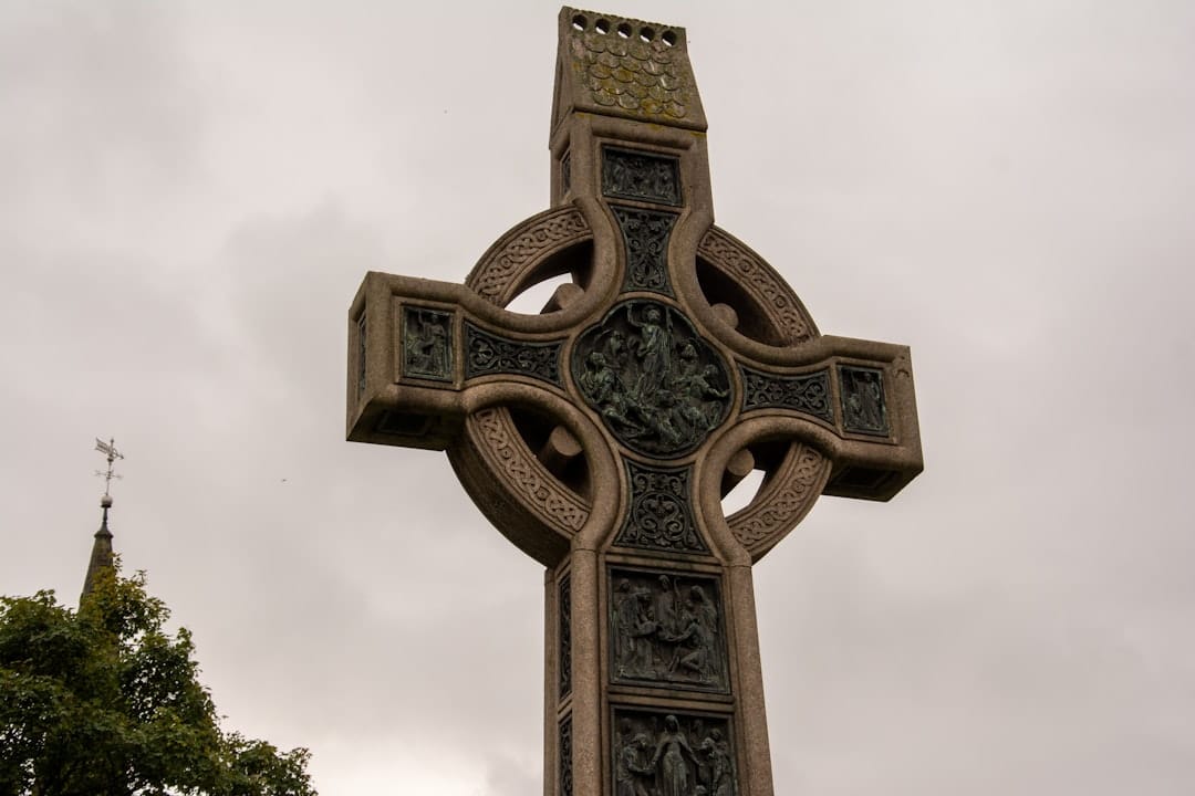 Ornate celtic cross against a cloudy sky
