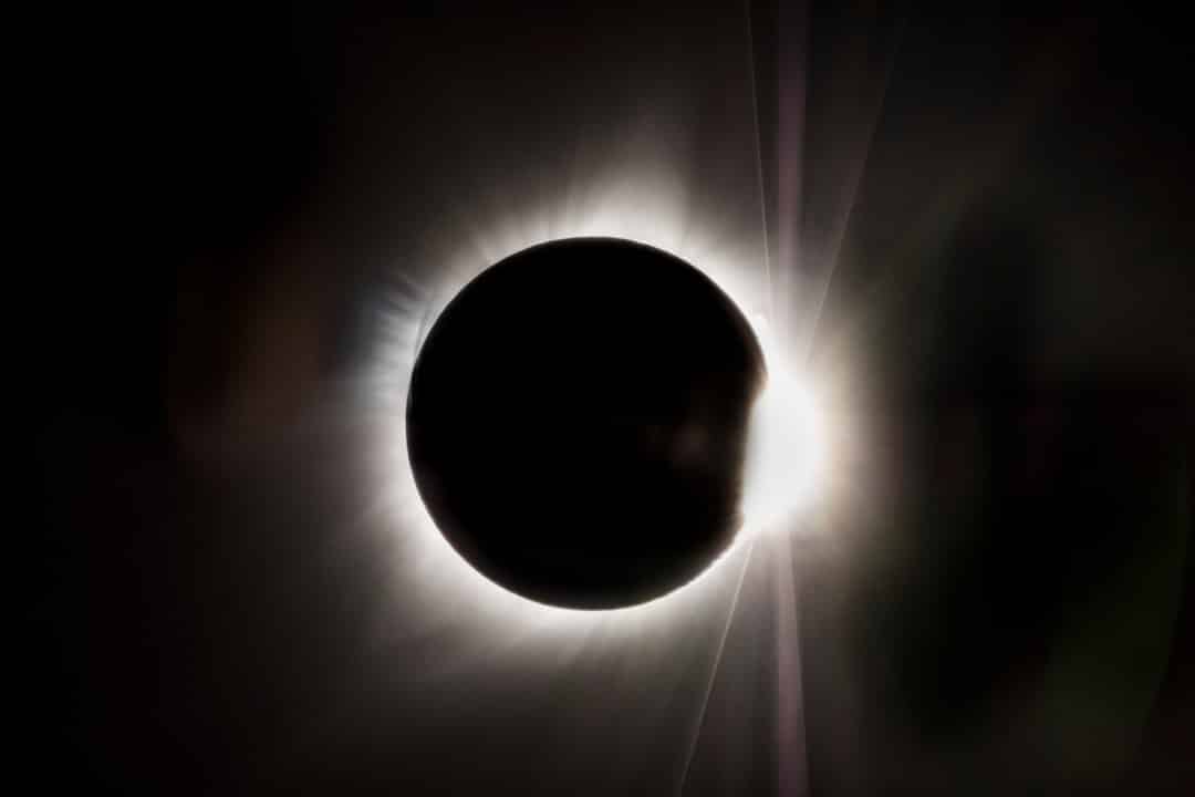a solar eclipse is seen in the dark sky